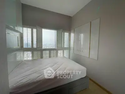 Modern bedroom with panoramic city view and stylish shutters