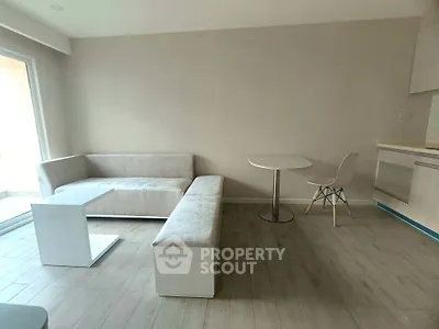 Modern minimalist living room with sleek furniture and natural light.