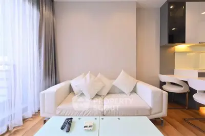Modern living room with white sofa and glass coffee table in a bright apartment