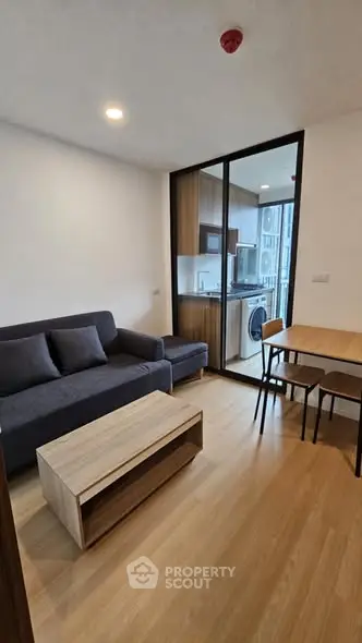 Modern living room with open kitchen layout and stylish furniture