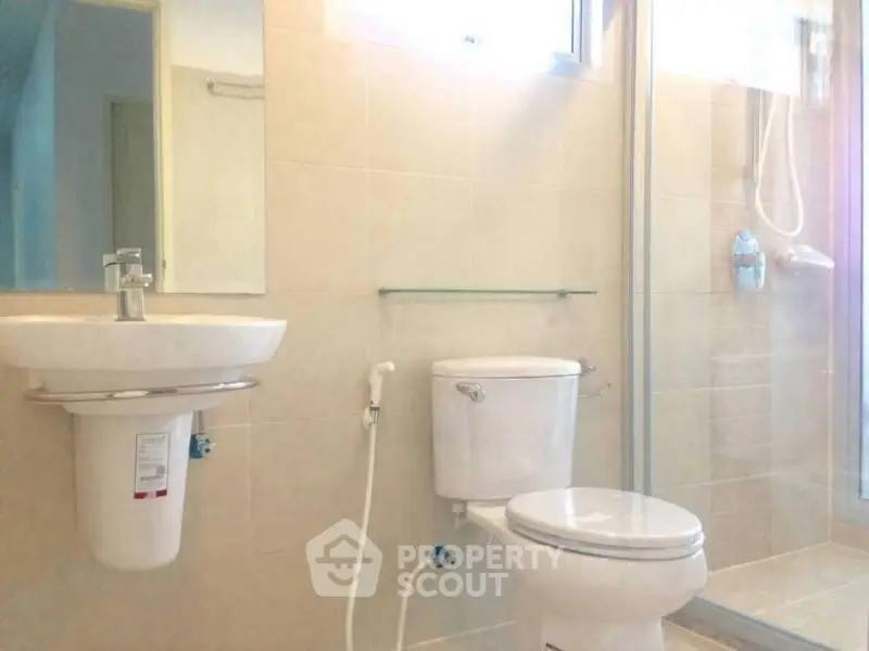 Modern bathroom with sleek fixtures and glass shower enclosure