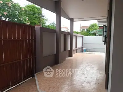 Spacious outdoor patio area with tiled flooring and privacy fencing, perfect for relaxation and entertainment.