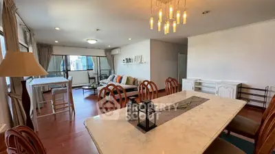 Spacious living and dining area with elegant lighting and city view balcony.