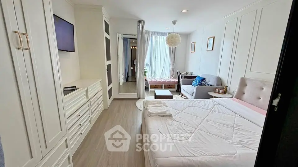 Spacious bedroom with elegant decor and natural light