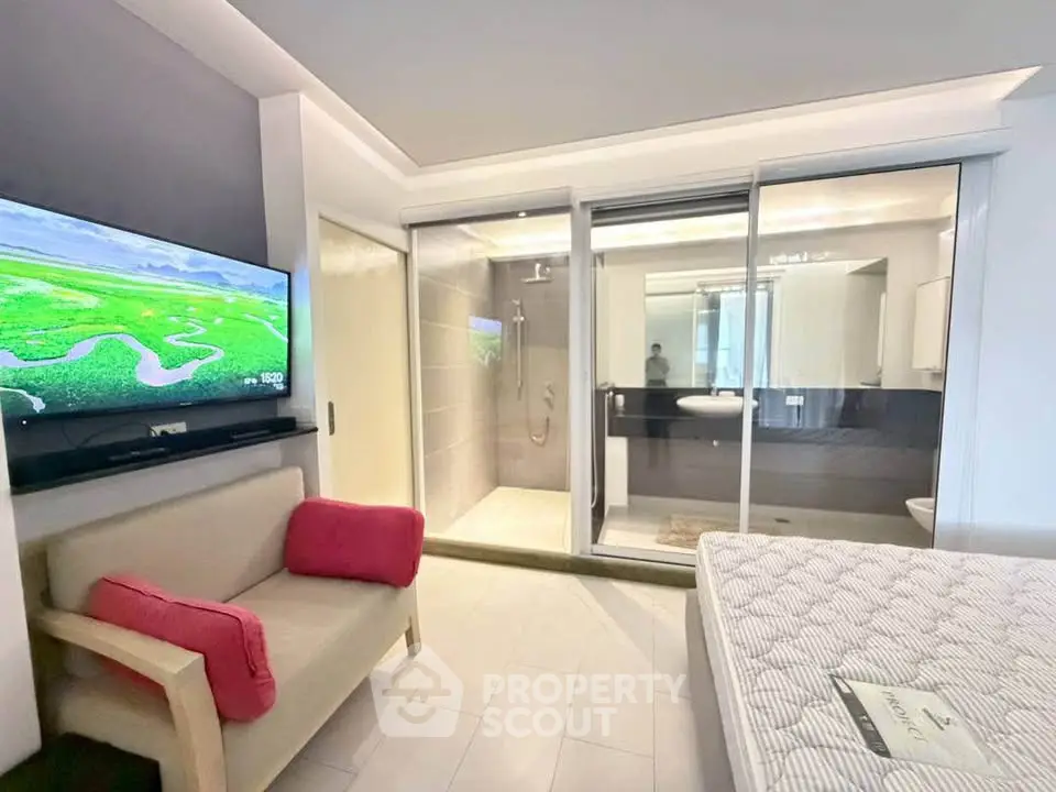 Modern studio apartment with open layout, featuring a cozy living area, sleek bathroom, and stylish decor.