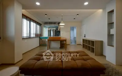 Spacious open-plan living room with modern kitchen and stylish furnishings