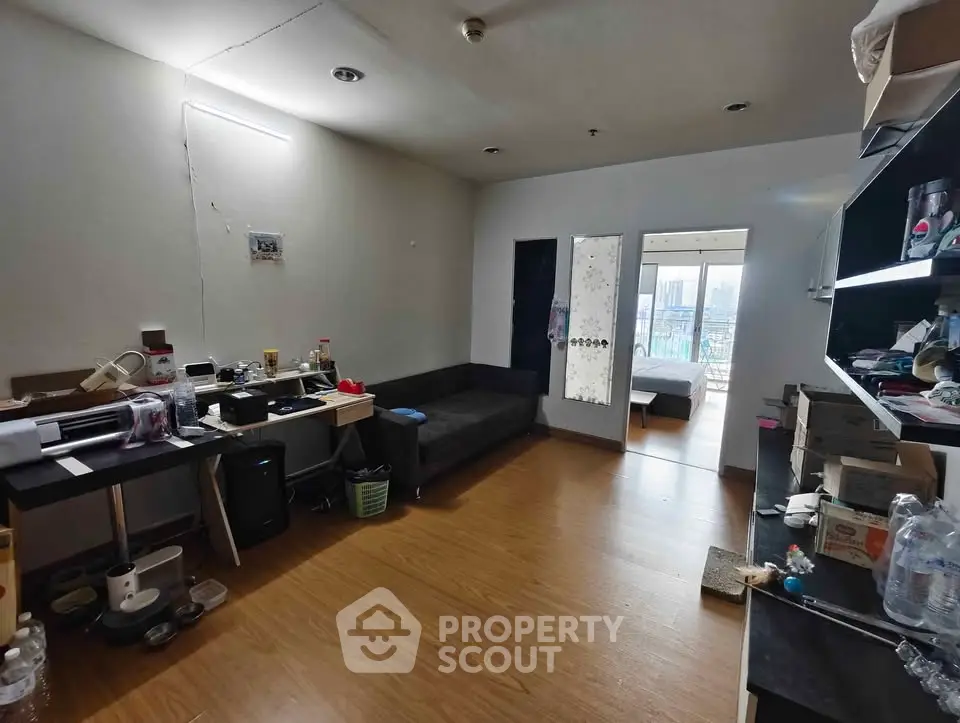 Spacious living room with wooden flooring and city view, ideal for modern urban living.