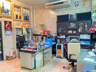 Cozy home office with bookshelves, desks, and air conditioning, ideal for productivity and comfort.