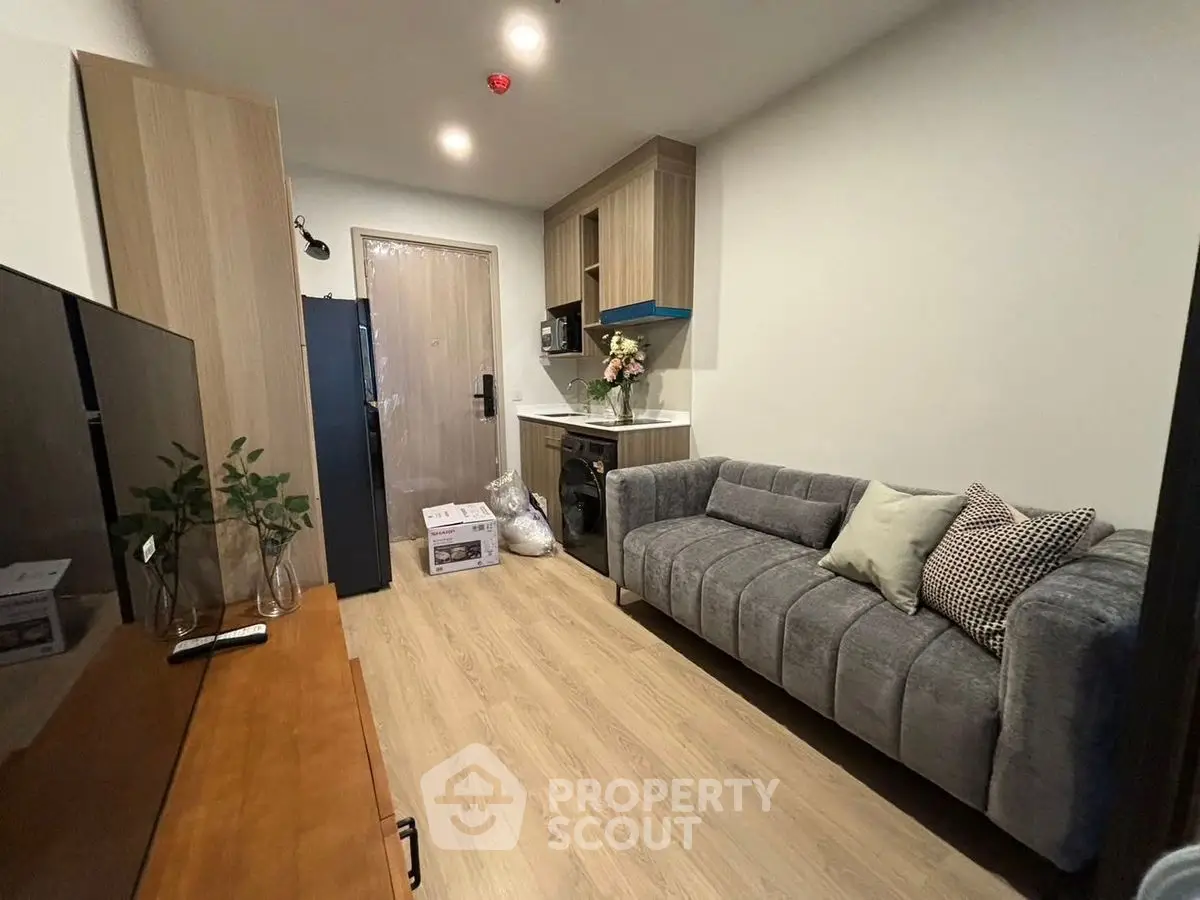 Modern living room with sleek furniture and stylish decor in a cozy apartment setting.