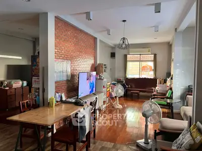 Spacious living room with brick accent wall and modern decor