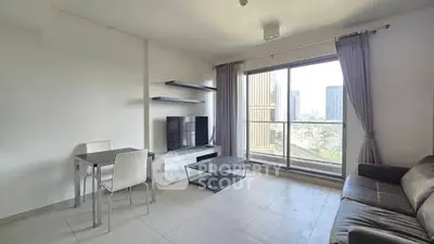 Modern living room with city view, featuring sleek furniture and large windows for natural light.