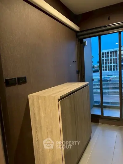 Modern balcony with wooden cabinet and city view