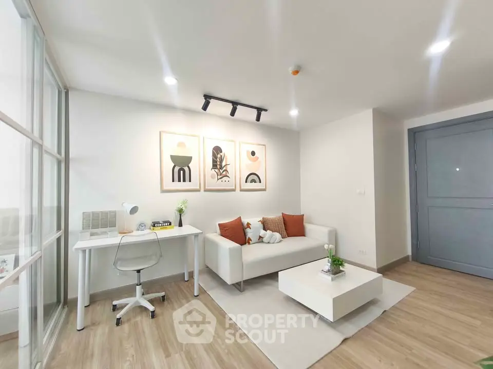 Modern living room with stylish decor and workspace in a bright apartment.