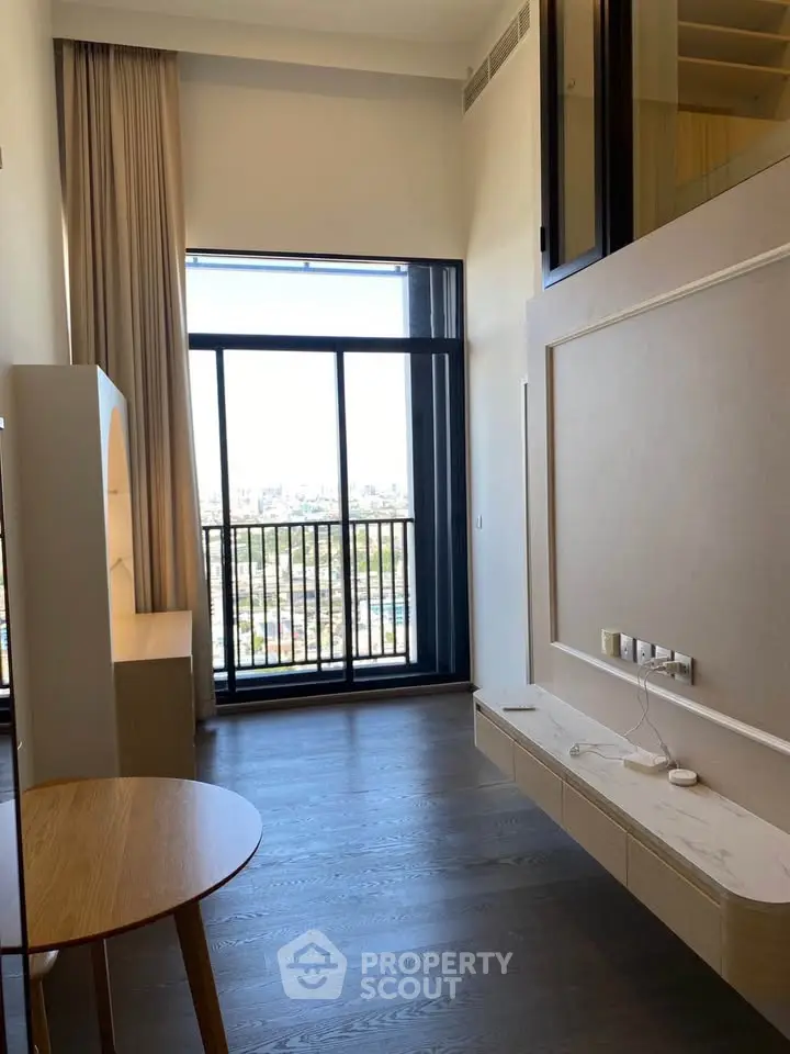 Modern apartment with floor-to-ceiling windows and city view, featuring elegant wood flooring and minimalist design.