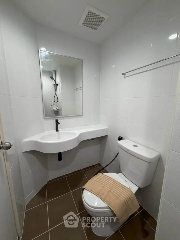 Modern bathroom with sleek white fixtures and contemporary design.