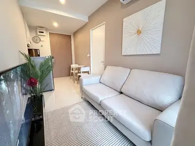 Modern living room with cozy sofa and stylish decor in a contemporary apartment.