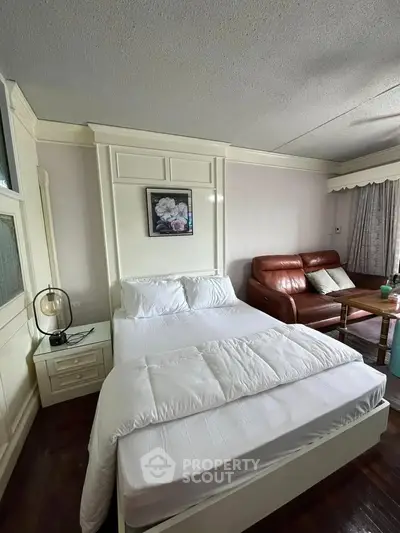 Cozy bedroom with elegant decor and comfortable seating area