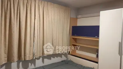 Cozy bedroom with built-in shelves and neutral curtains, perfect for a restful retreat.
