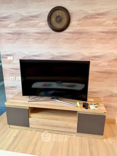 Modern living room with stylish TV stand and wall clock, perfect for cozy entertainment nights.