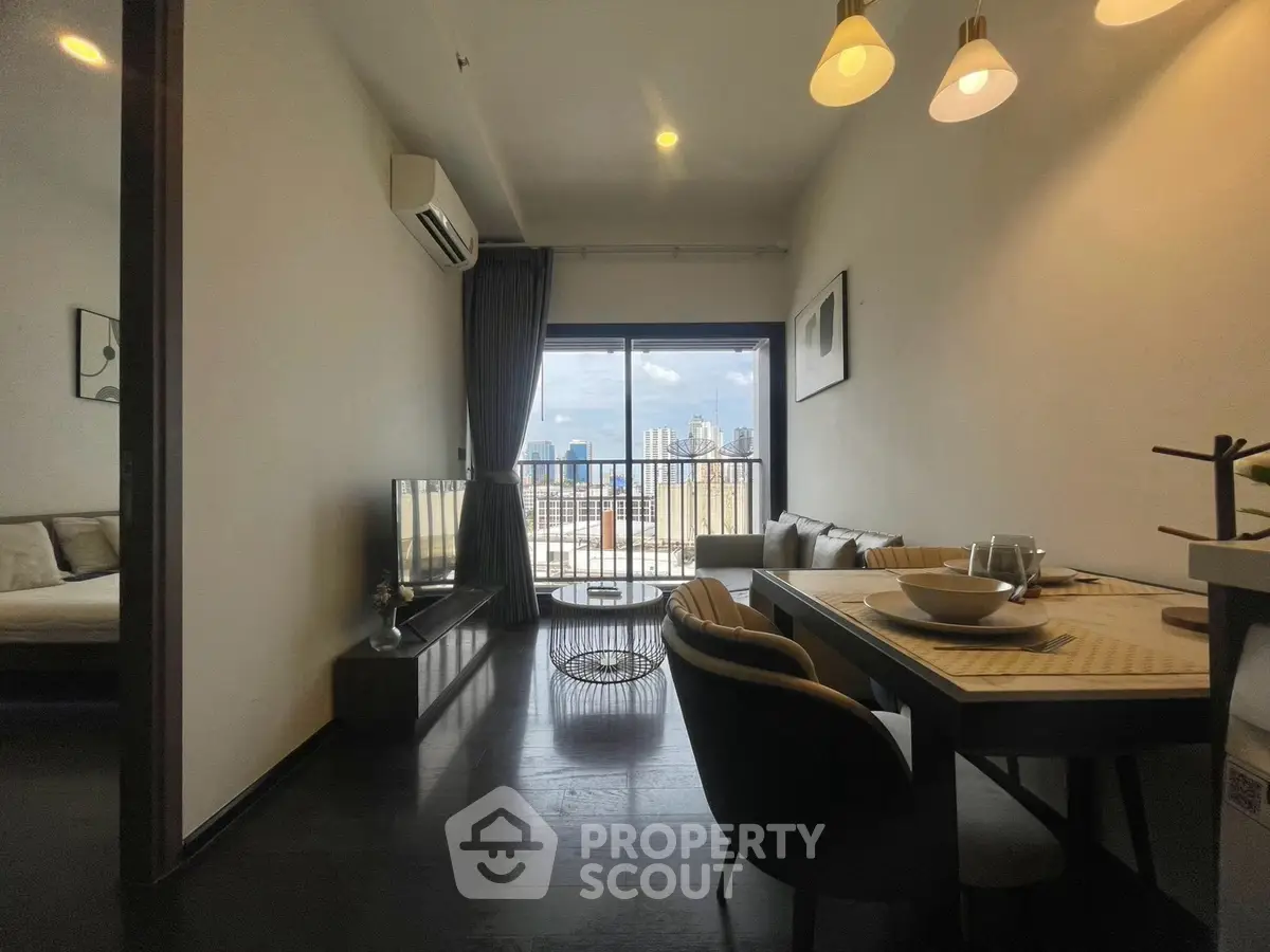 Modern living room with dining area and city view balcony in stylish apartment.