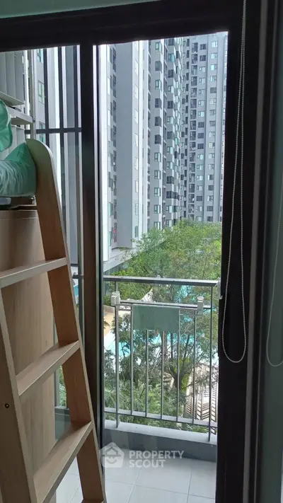 Modern apartment balcony with pool view in high-rise building