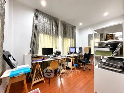 Spacious home office with wooden flooring and modern furniture
