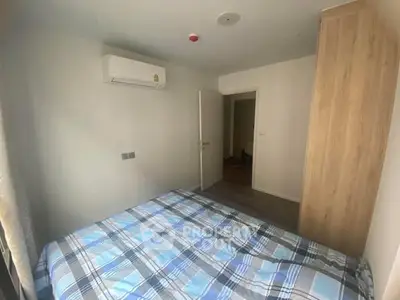 Cozy bedroom with modern air conditioning and wooden wardrobe