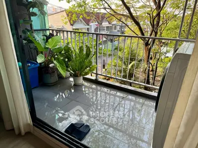 Charming balcony with lush greenery and scenic neighborhood view, perfect for relaxation and enjoying nature.