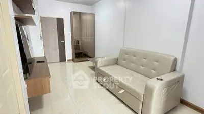 Modern living room with sleek beige sofa and stylish TV unit