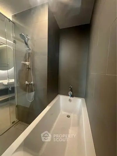 Modern bathroom with sleek bathtub and glass shower enclosure