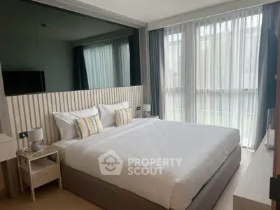 Luxurious bedroom with large windows and modern decor, perfect for relaxation and comfort.