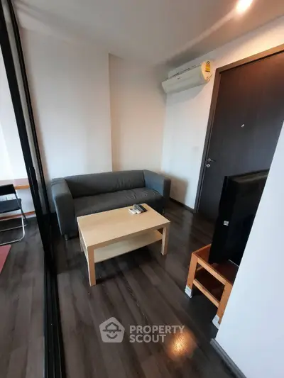 Cozy living room with modern sofa and TV, perfect for relaxation.