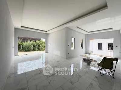 Spacious modern living room with glossy marble floors and large windows