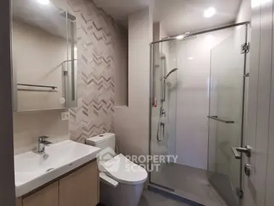 Modern bathroom with glass shower and stylish tile design