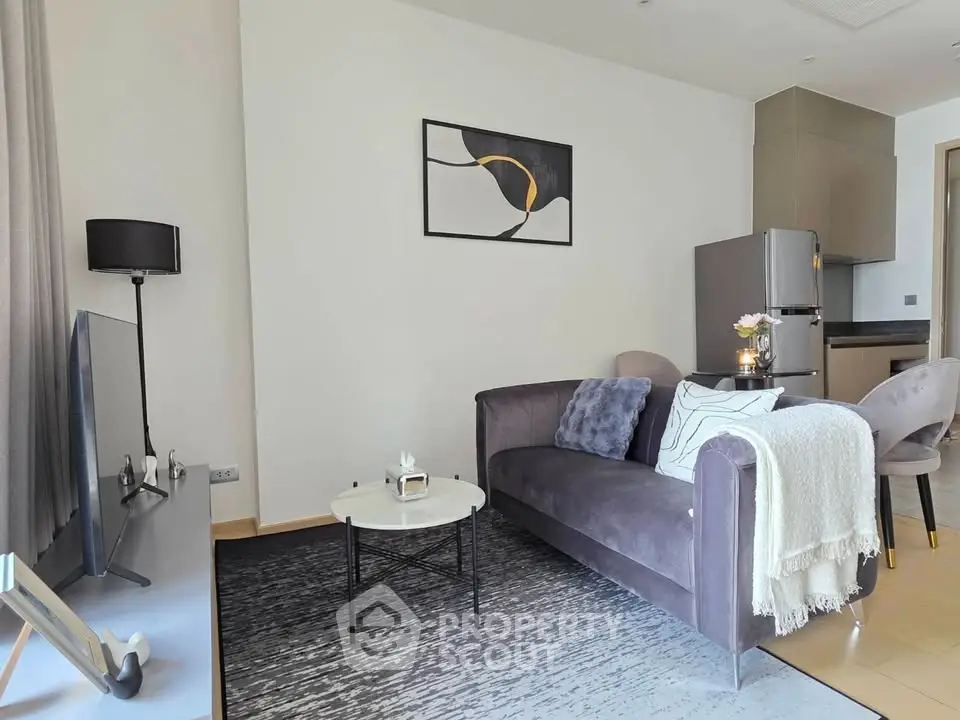 Modern living room with stylish decor and open kitchen layout in a cozy apartment.