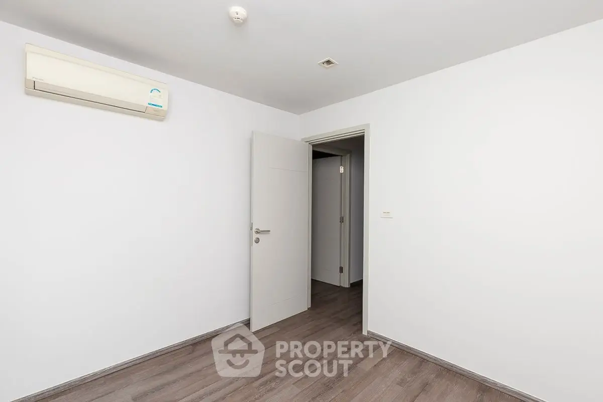 Minimalist empty room with air conditioning and wooden flooring