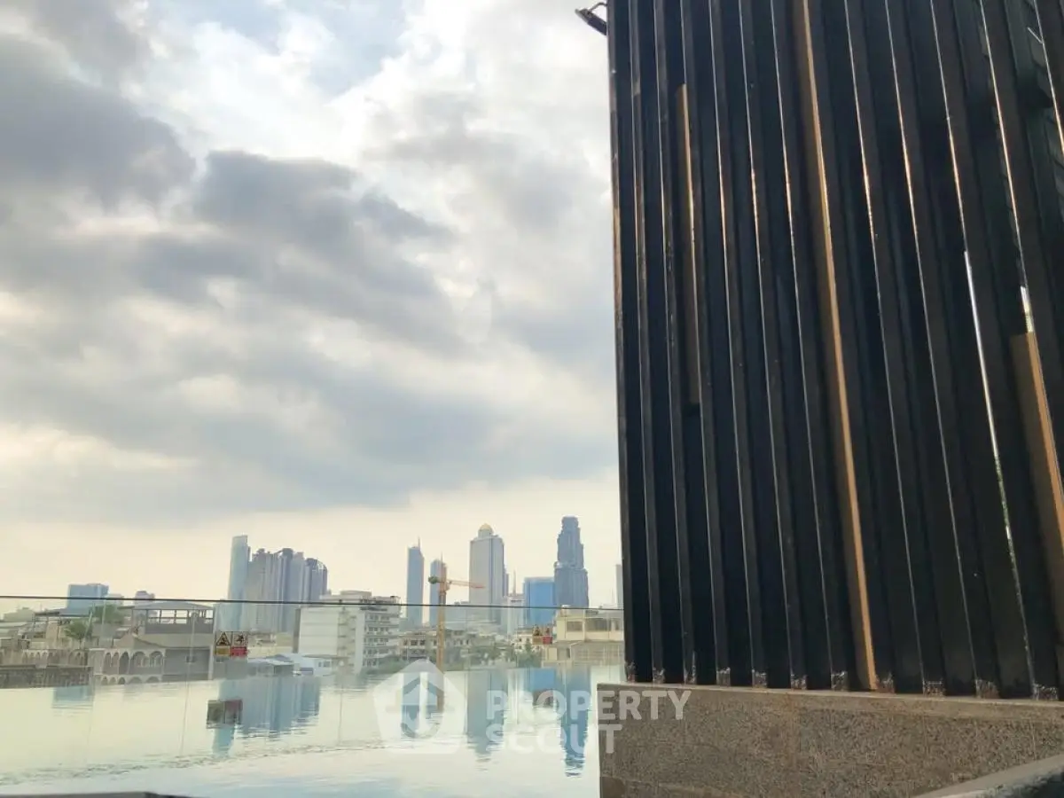 Stunning city skyline view from a modern rooftop pool area.