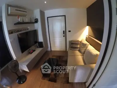 Modern living room with sleek furniture and entertainment setup, featuring a cozy sofa and stylish decor.