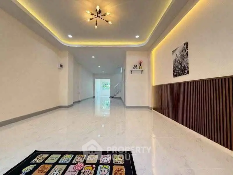 Spacious modern living room with elegant lighting and glossy flooring