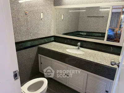 Modern bathroom with granite countertops and sleek design