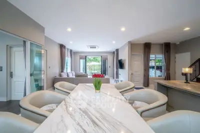 Spacious modern living room with elegant dining area and natural light