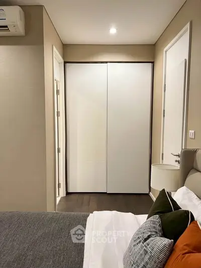Modern bedroom with sleek design and cozy ambiance, featuring a comfortable bed and stylish decor.