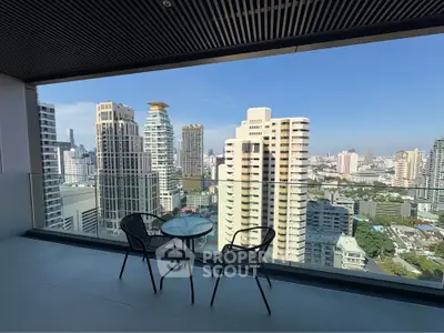 Stunning city view from modern balcony with glass railing and seating area.