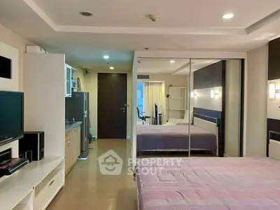 Spacious modern bedroom with mirrored closet and stylish decor