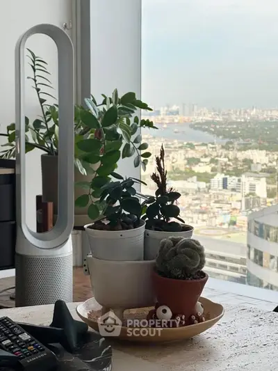 Stylish modern living room with panoramic city view and lush indoor plants.