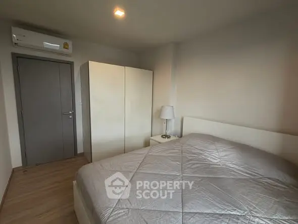 Cozy bedroom with modern furnishings and ample natural light.