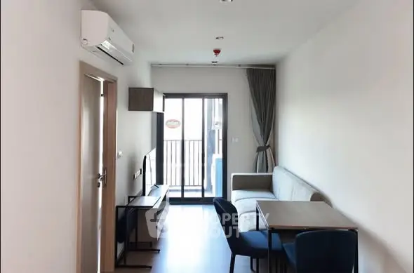 Modern living room with balcony access and sleek furniture