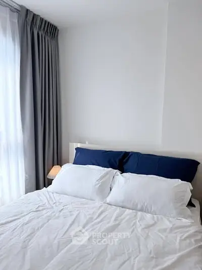 Cozy bedroom with elegant curtains and soft lighting, perfect for relaxation.
