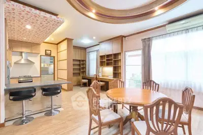 Spacious open-plan living area with modern kitchen and elegant dining space