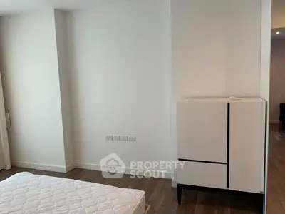 Minimalist bedroom with modern furniture and hardwood flooring
